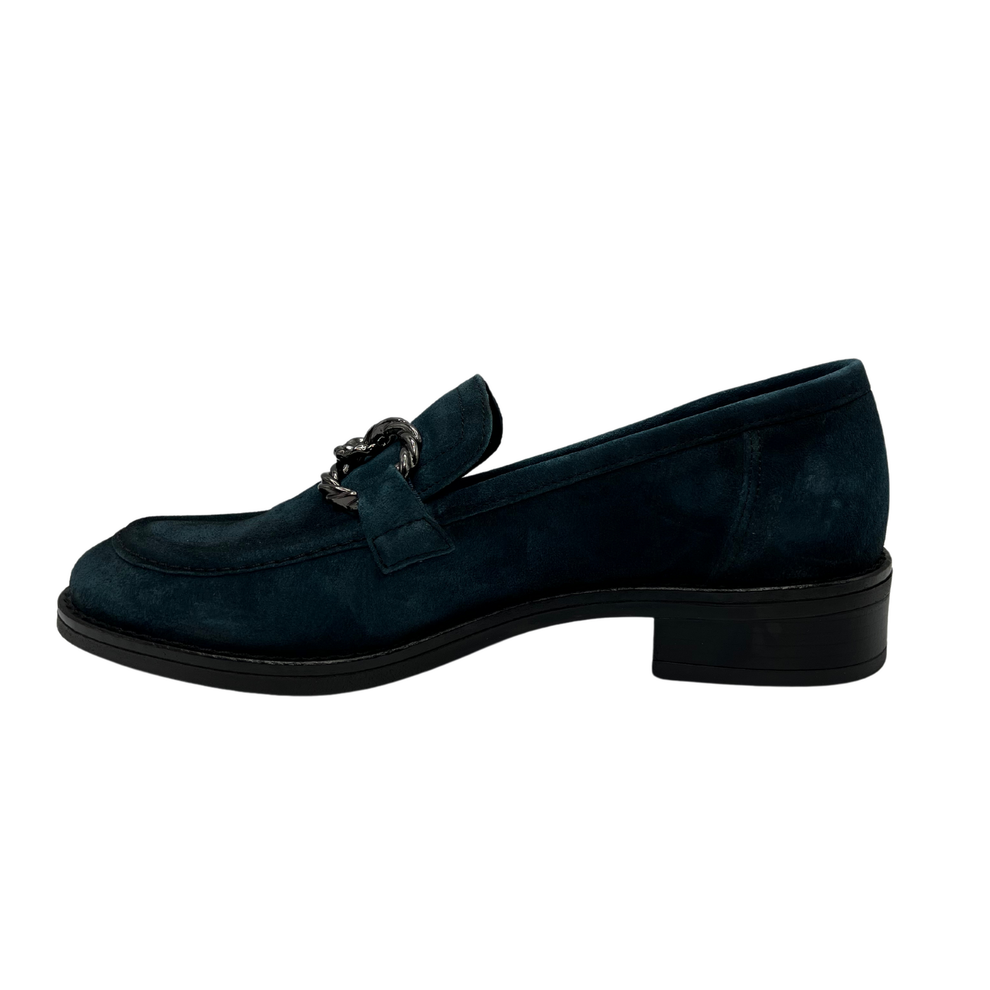 Left facing view of blue suede loafer with short block heel and metal embellishment on the upper