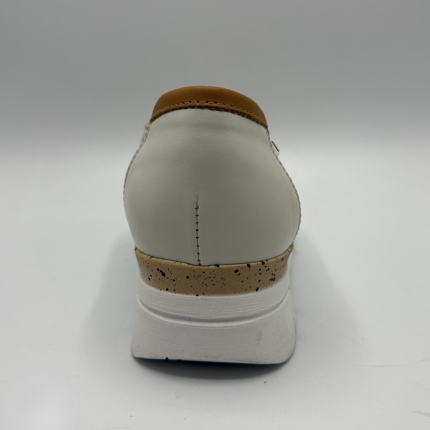 White shoe with brown accents on a white background