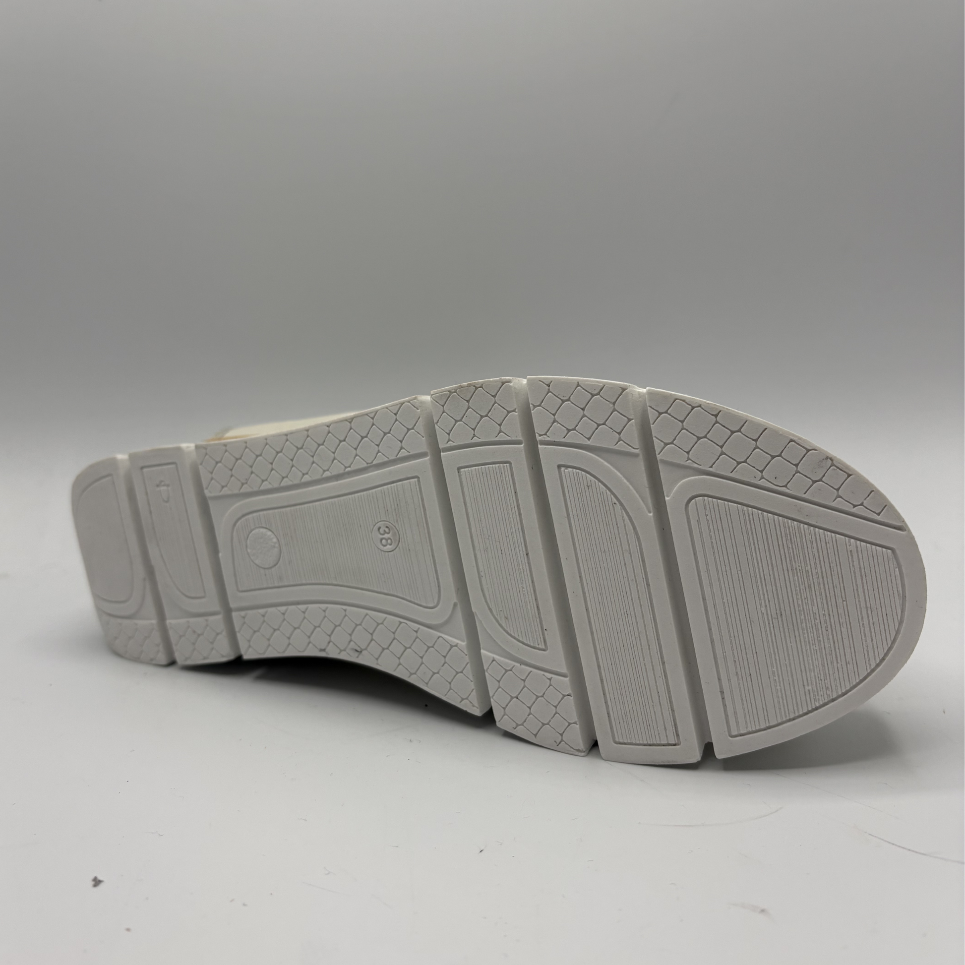 Gray shoe sole with tread pattern on a gray background