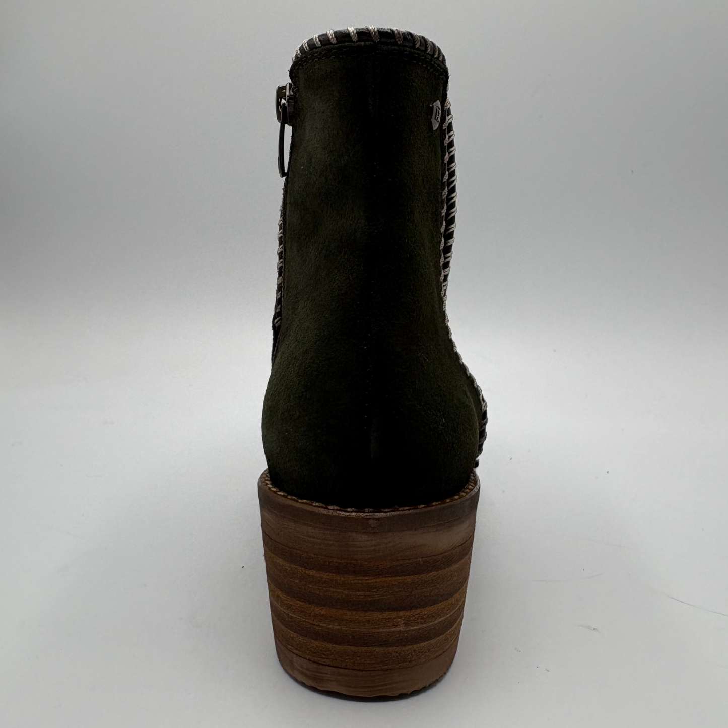 A dark olive green suede ankle boot with a chunky brown wooden block heel, shown from a rear three-quarter view against a neutral gray background.