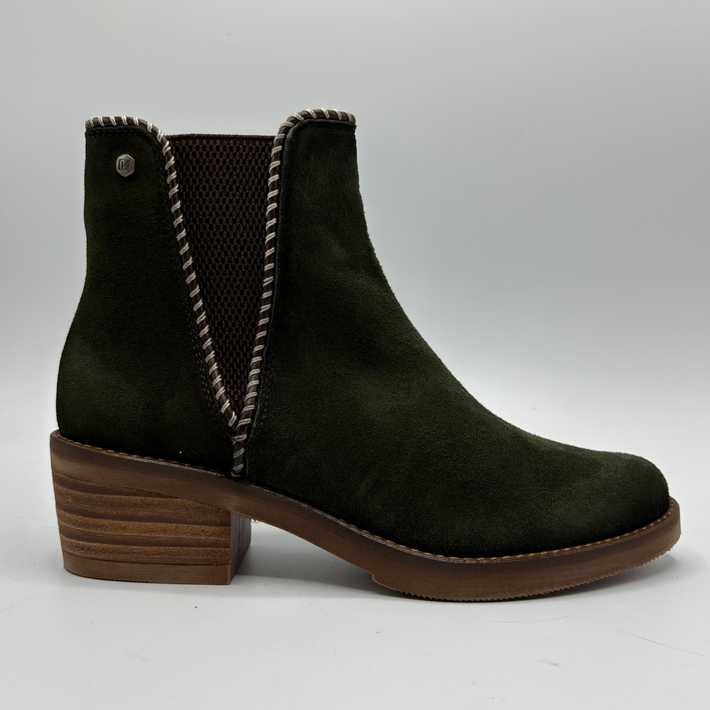 A dark olive green suede ankle boot with a brown stacked wooden-look block heel, brown sole, and brown mesh elastic side panels.
