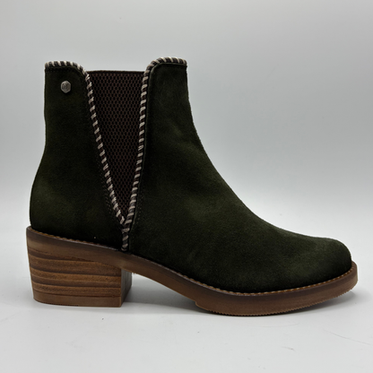 A dark olive green suede ankle boot with a brown stacked wooden-look block heel, brown sole, and brown mesh elastic side panels.