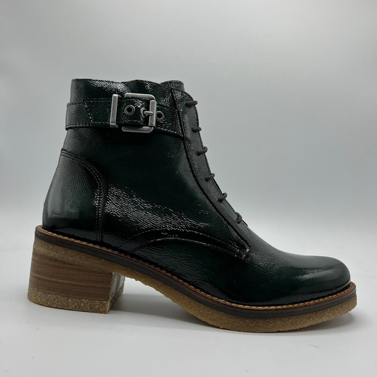 Green leather boot with a brown sole on a grey background