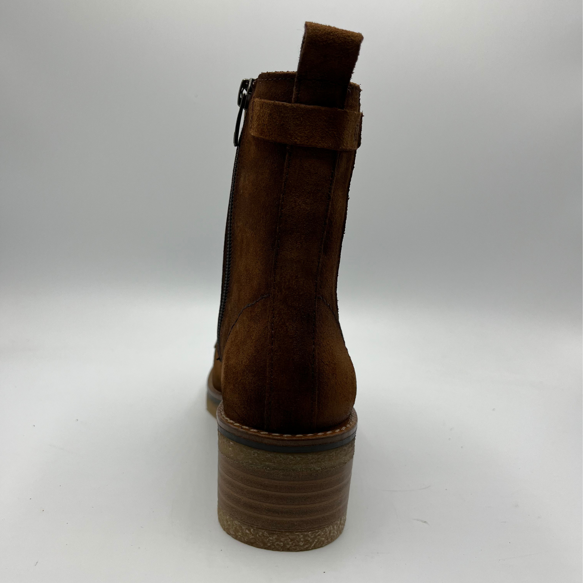 Brown suede boot on a white background