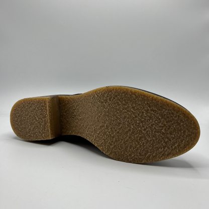 Close-up of a brown shoe sole on a white background