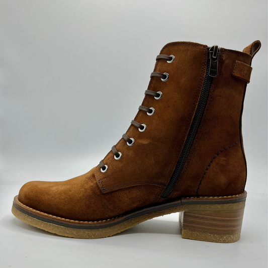 Brown leather boot with a buckle on a white background