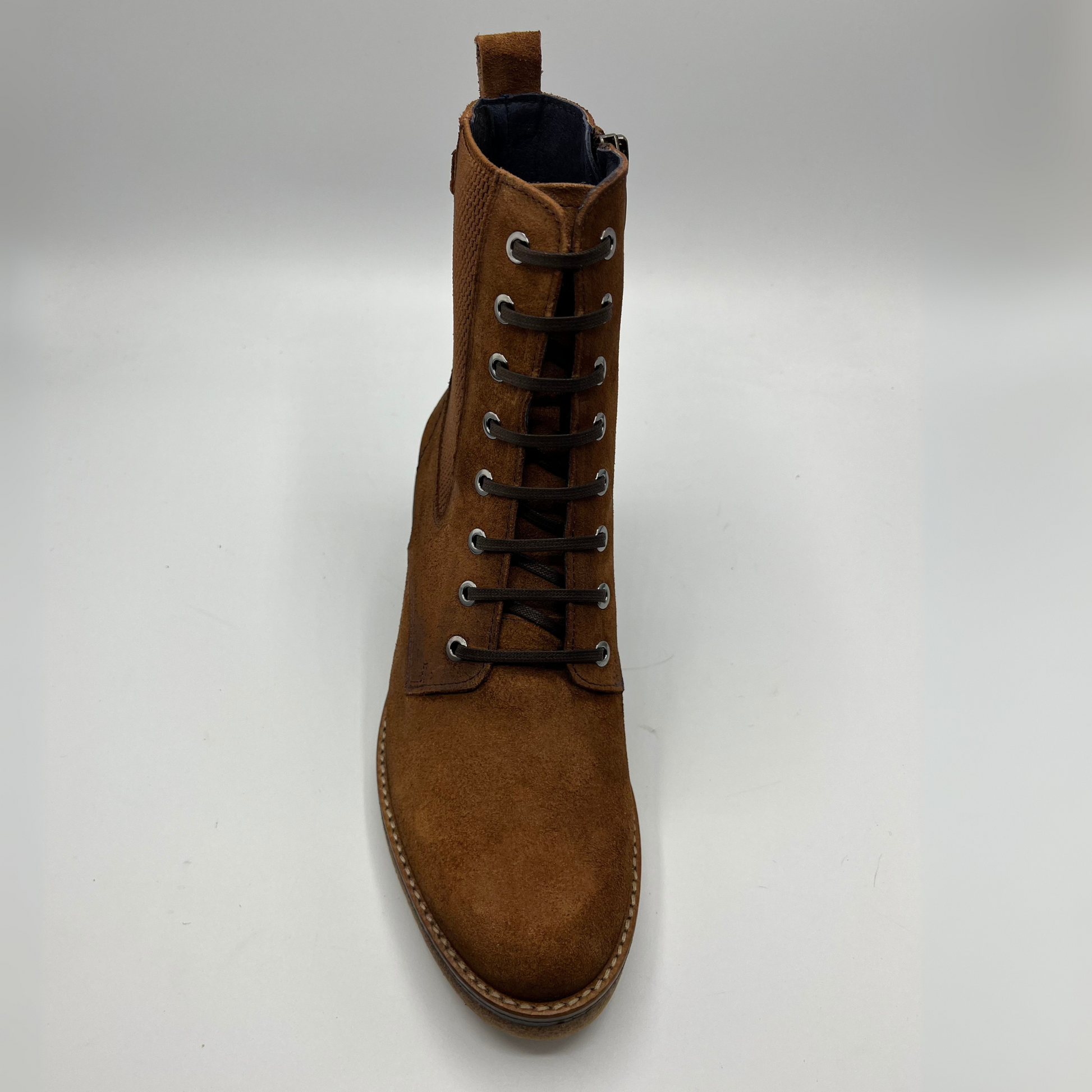 Brown suede boot on a white background
