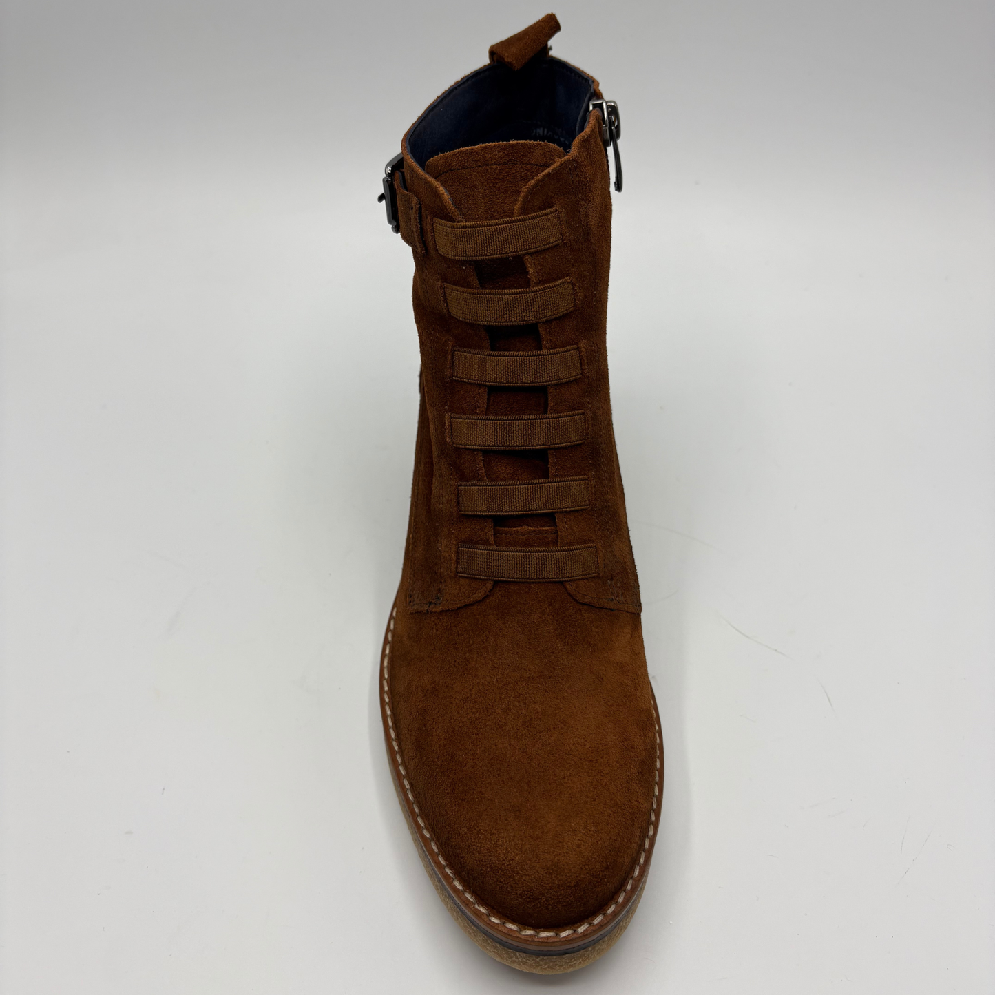 A brown suede lace-up ankle boot with a side zipper, shown from a top-down angle on a light gray background.