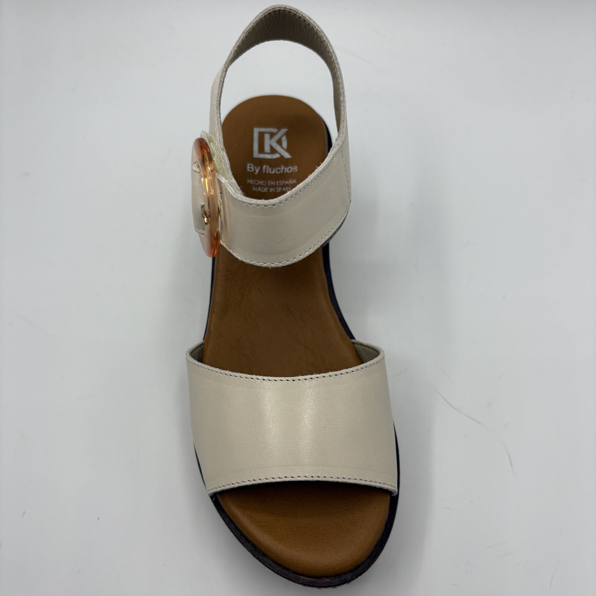 Beige sandal with brown sole on a white background