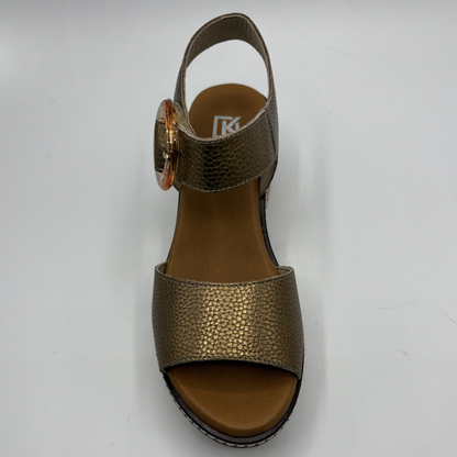 Gold sandal with a strap on a white background