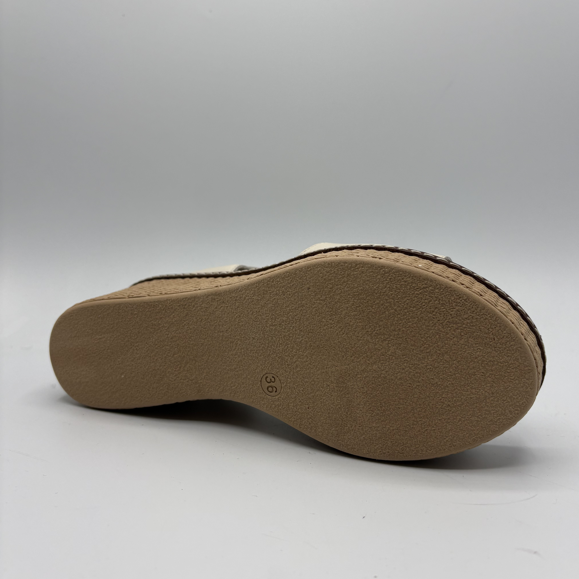 Brown sandal sole on a light gray background
