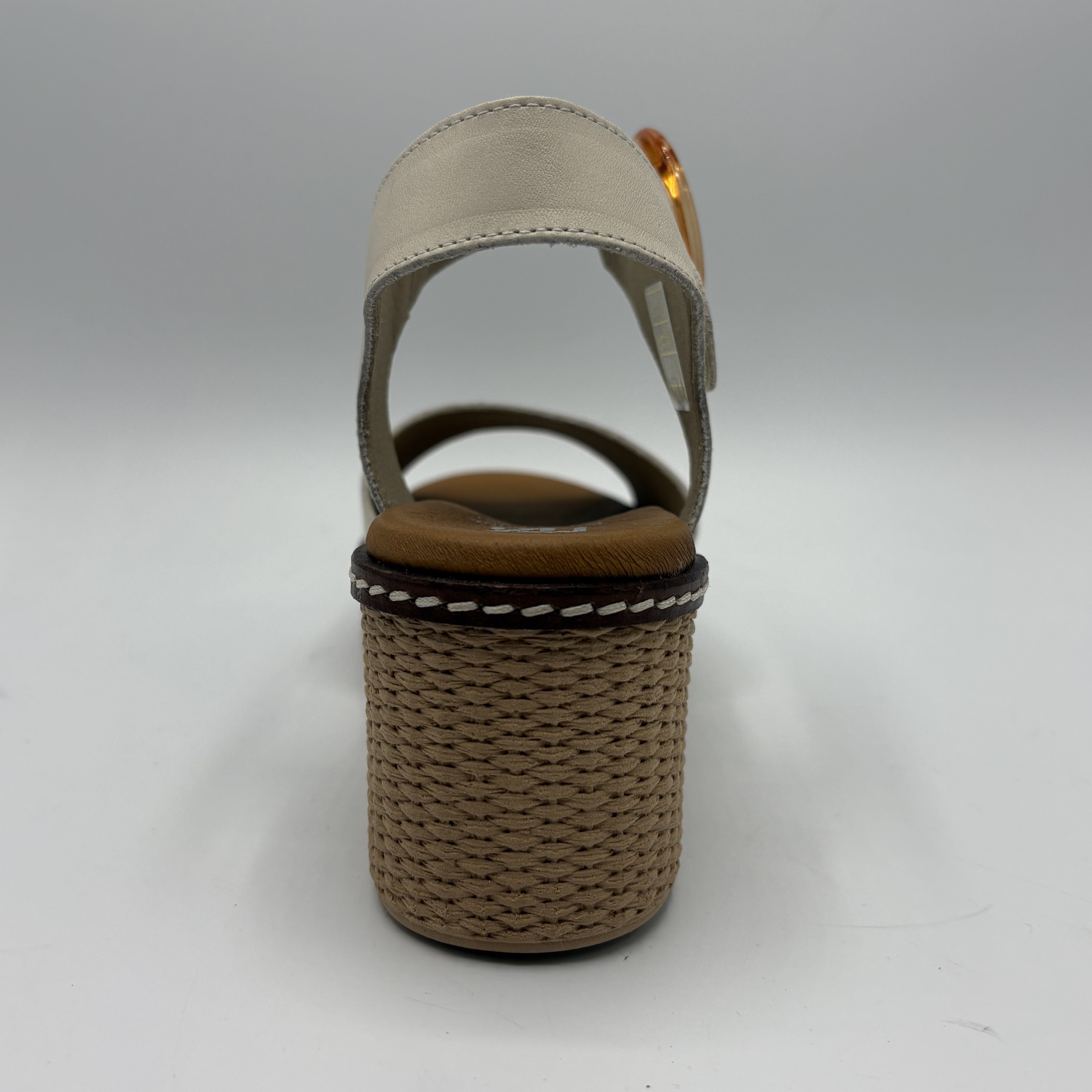 Beige sandal with woven sole on a gray background