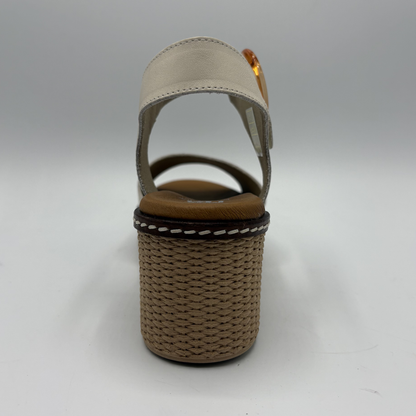 Beige sandal with woven sole on a gray background