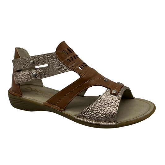 45 degree angled view of brown and metallic leather strapped sandal with rubber outsole