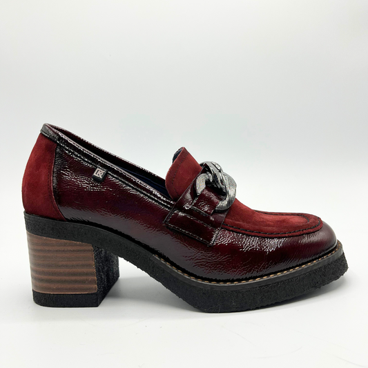 Red leather shoe with a block heel on a white background