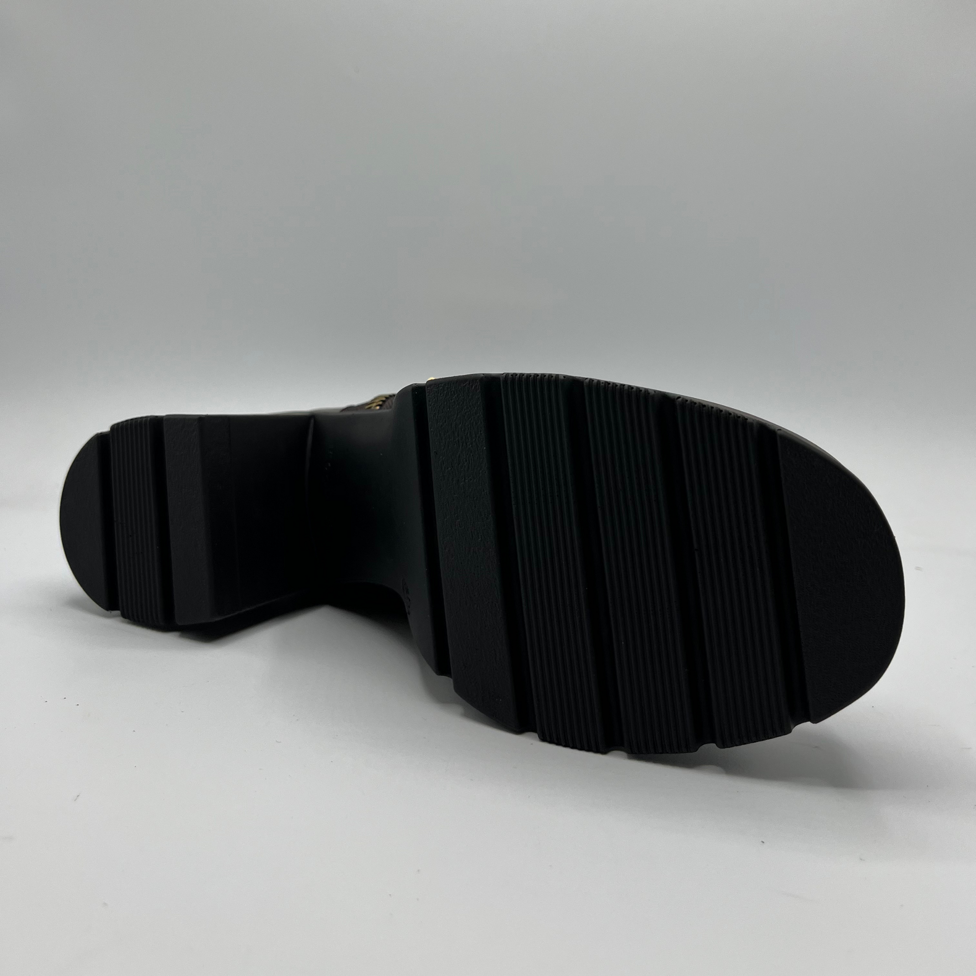 Black sole of a shoe on a gray background