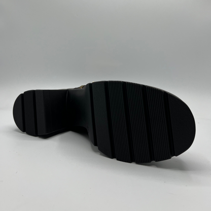 Black sole of a shoe on a gray background