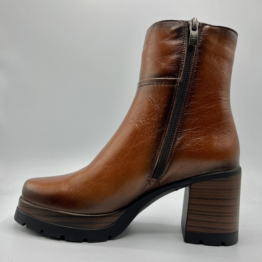 Brown leather ankle boot with a block heel on a white background