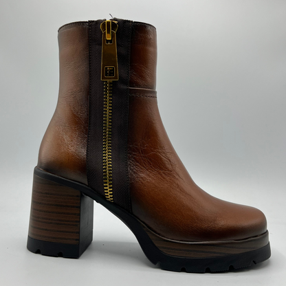 Brown leather boot with a gold zipper on a white background