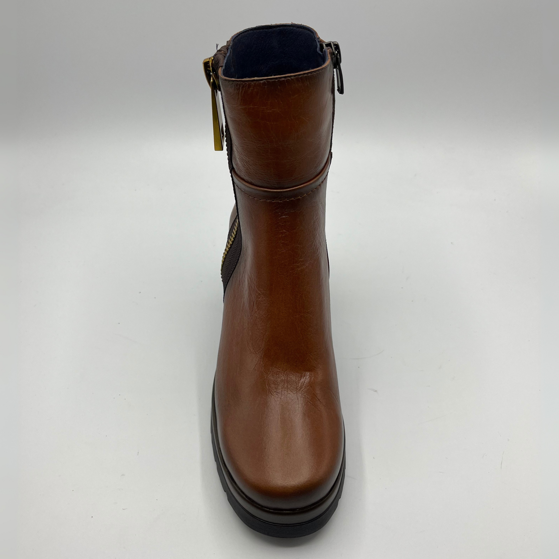 Brown leather boot with a black sole on a white background
