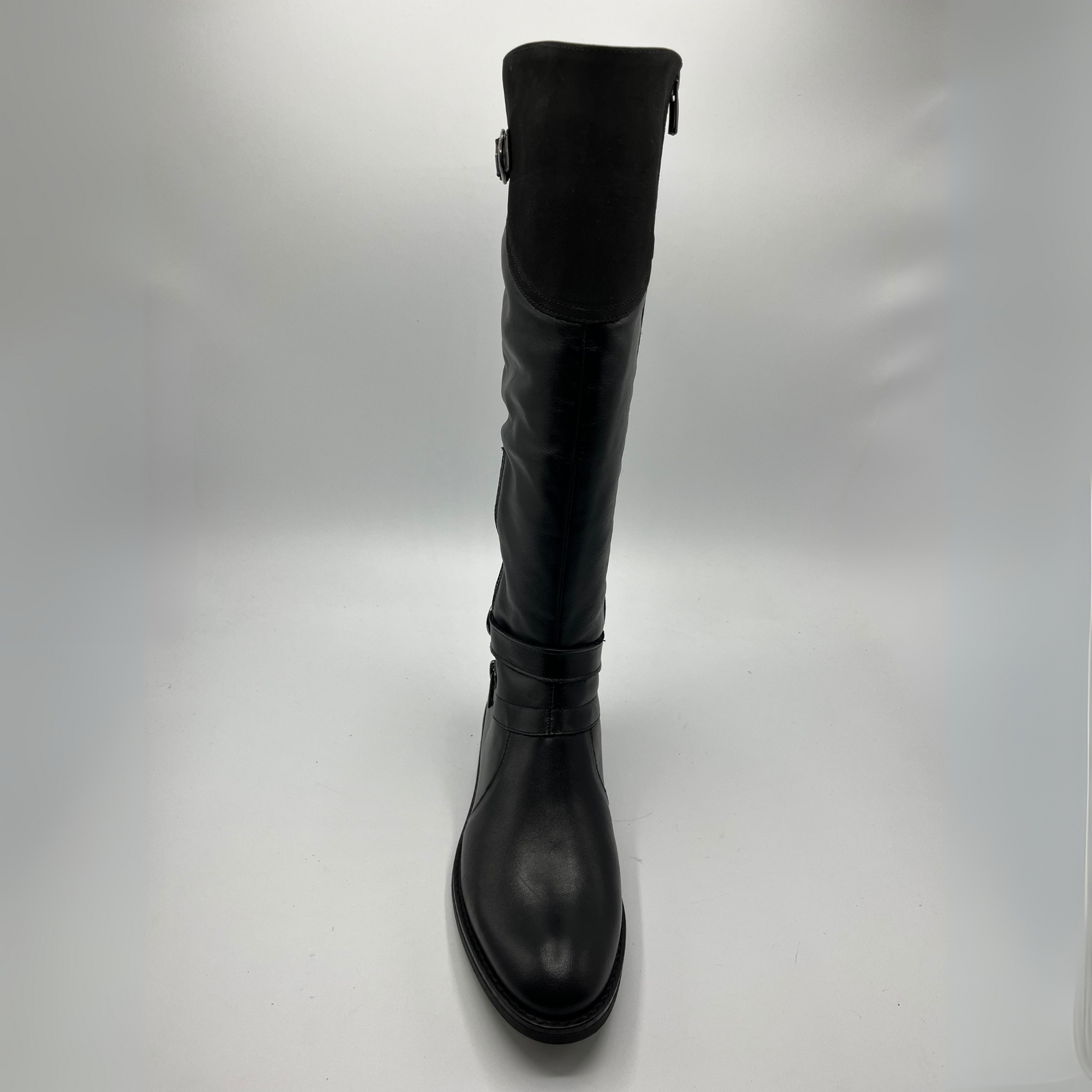 Black knee-high boot on a light gray background