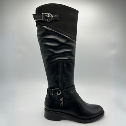 Black knee-high boot with silver buckles on a gray background