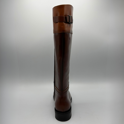 Back view of a tall brown leather boot with a decorative buckle and low black heel