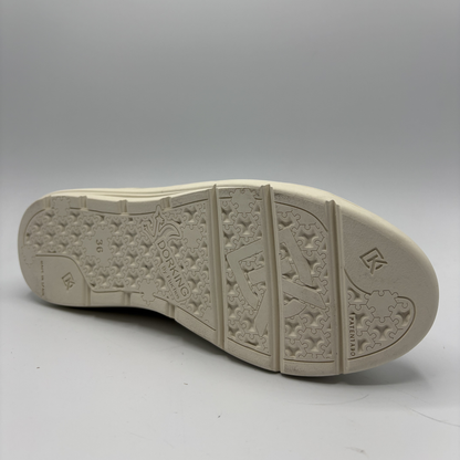 Beige shoe sole with brand logo on a gray background