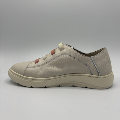 Beige sneaker on a gray background