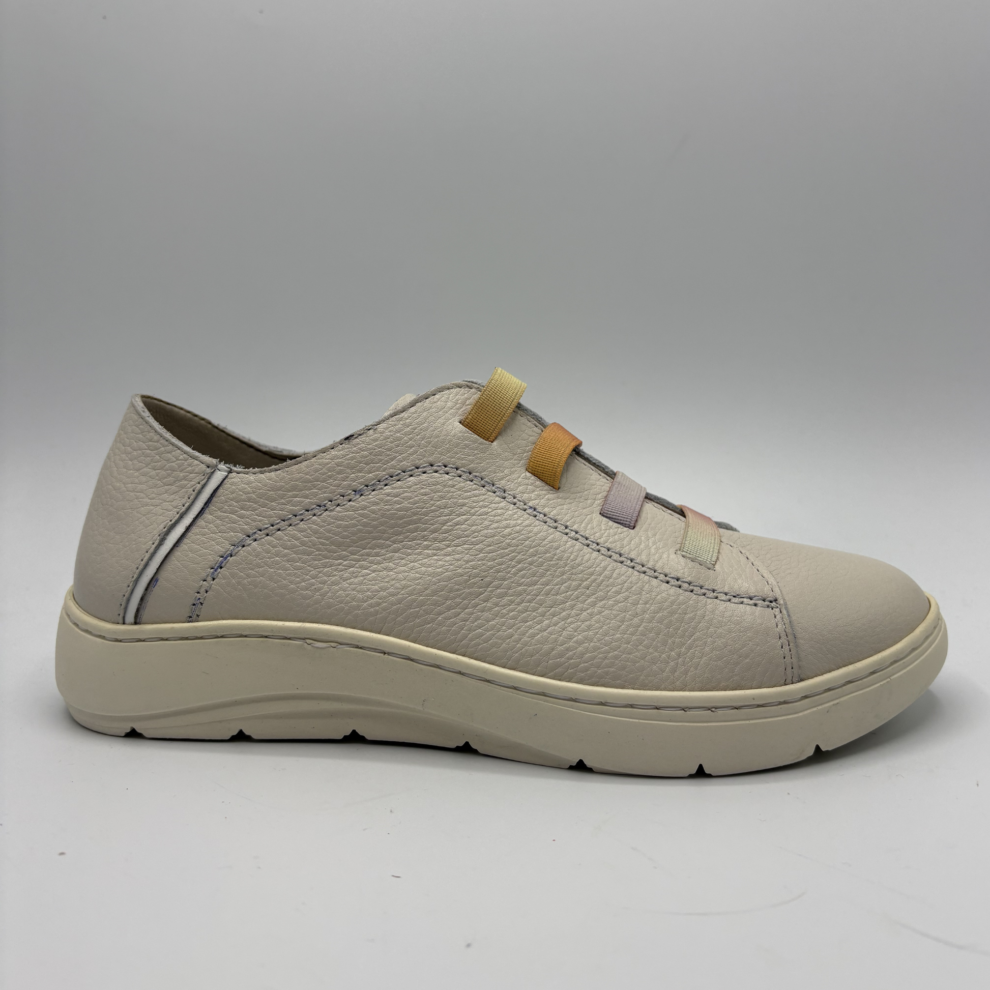 Beige sneaker on a gray background