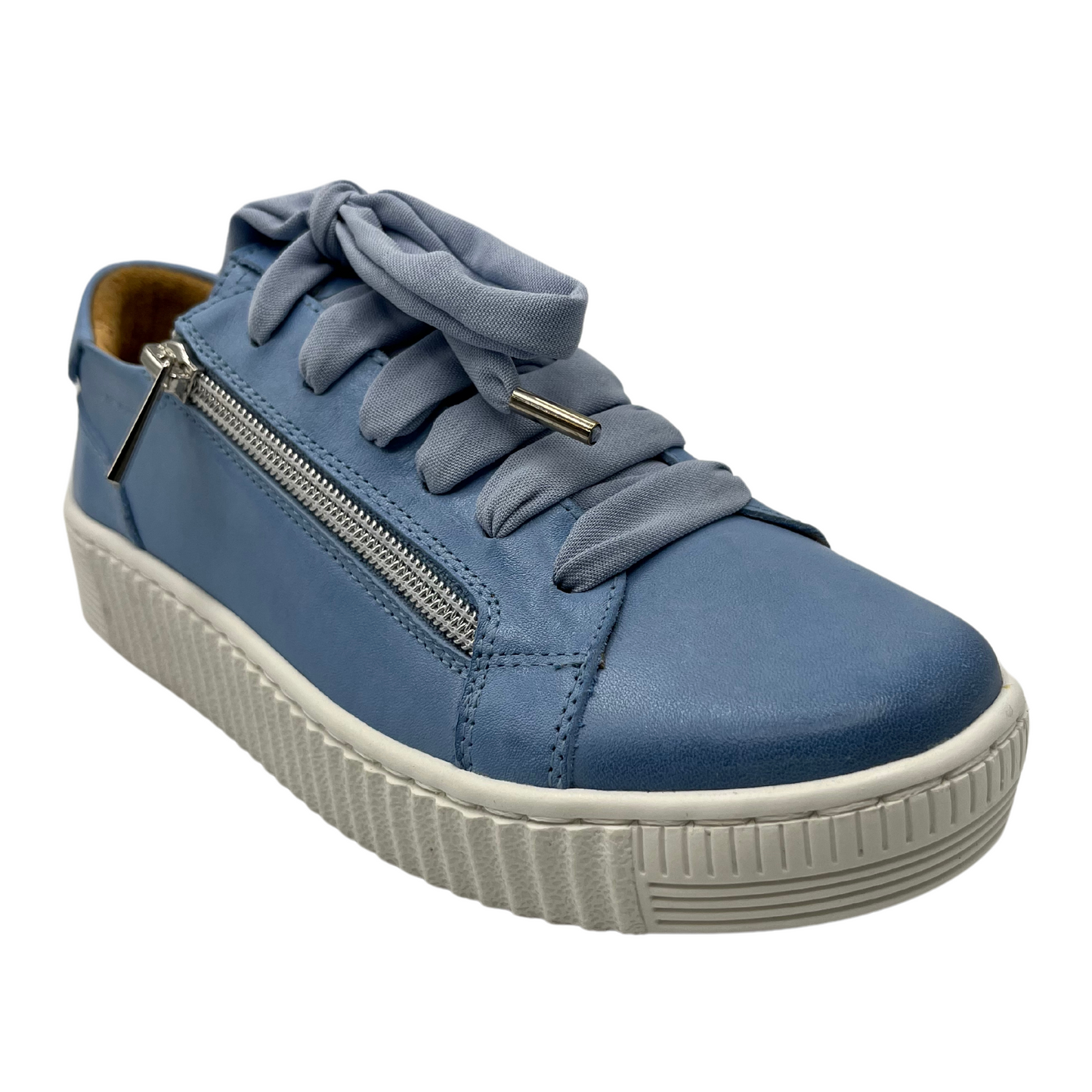 45 degree angled view of blue leather sneaker with matching laces and white rubber outsole