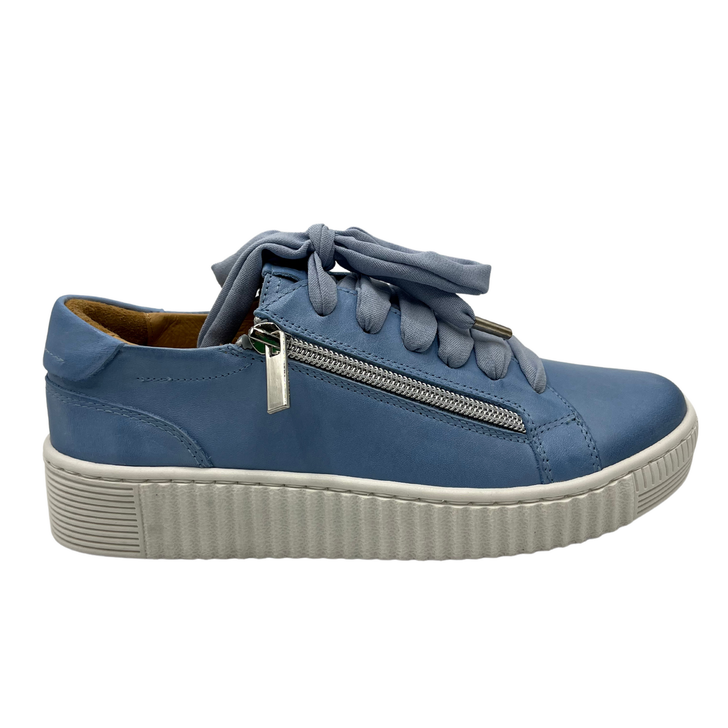 Right facing view of blue leather sneaker with white rubber outsole
