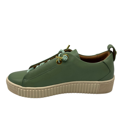 Left facing view of basil green leather sneaker with off white rubber outsole