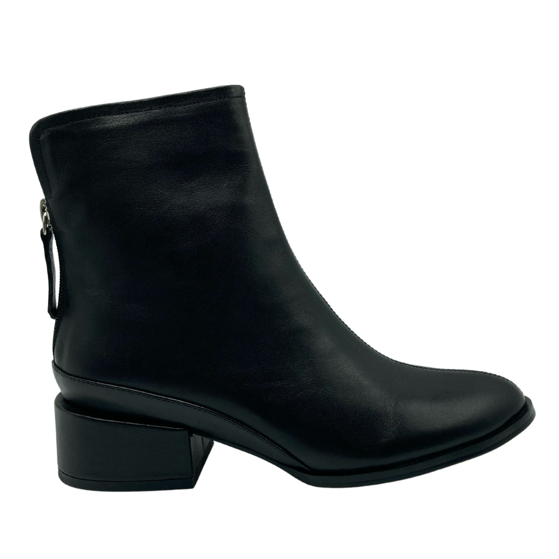 Right facing view of black ankle boot with block heel and zipper entry
