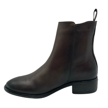 Left facing view of brown leather ankle boot with block heel and pull on tab