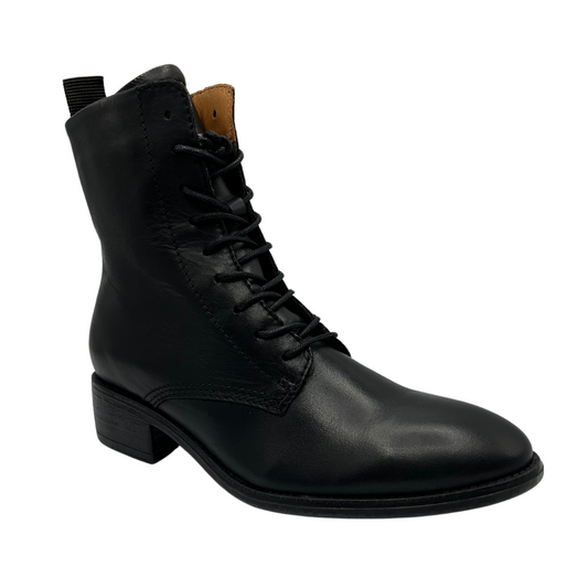 45 degree angled view of black leather lace up ankle boots with pull on heel tab and short block heel