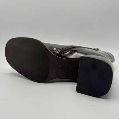 Bottom view of a dark brown short boot with an elastic side panel and a block heel