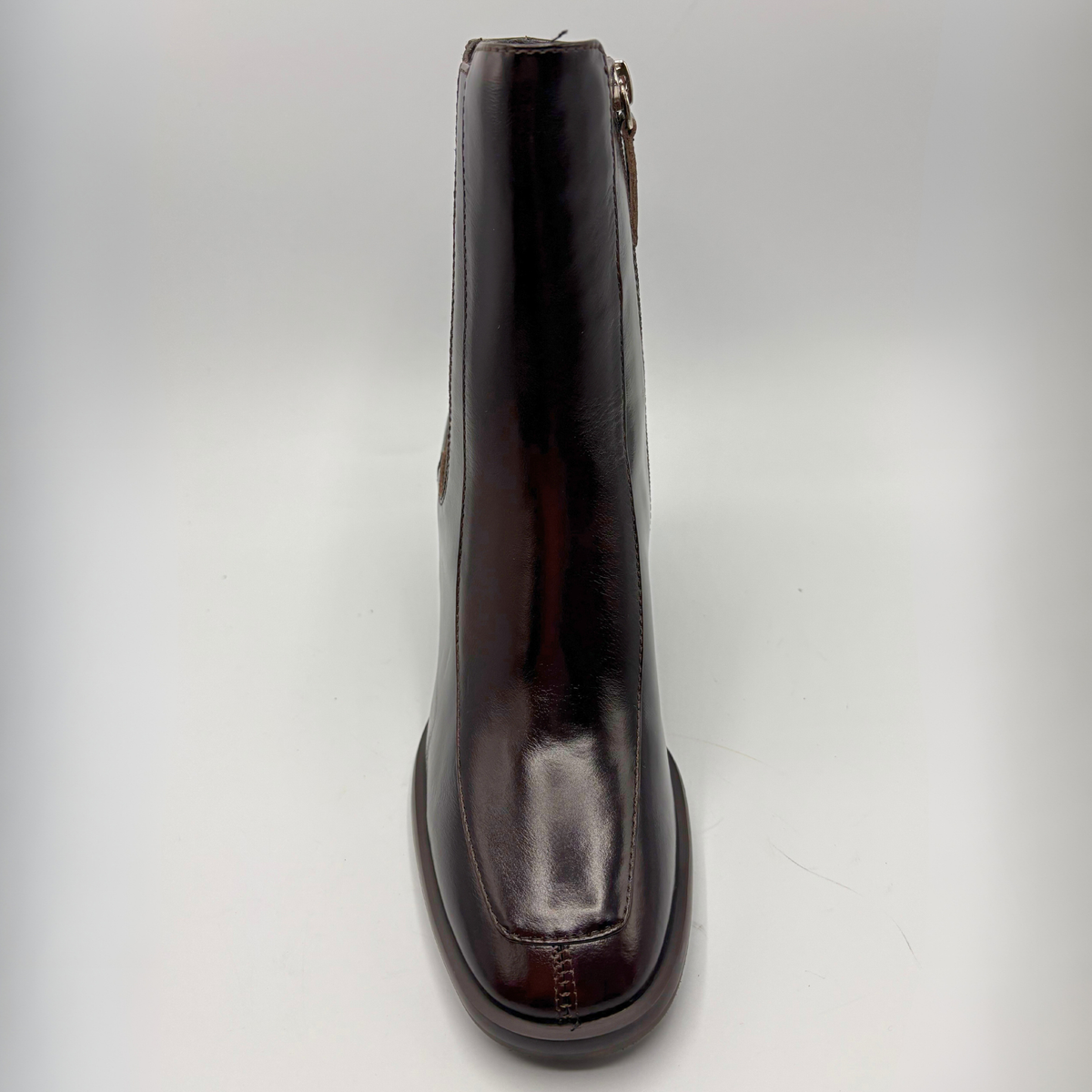 Top view of a dark brown short boot with an elastic side panel and a block heel