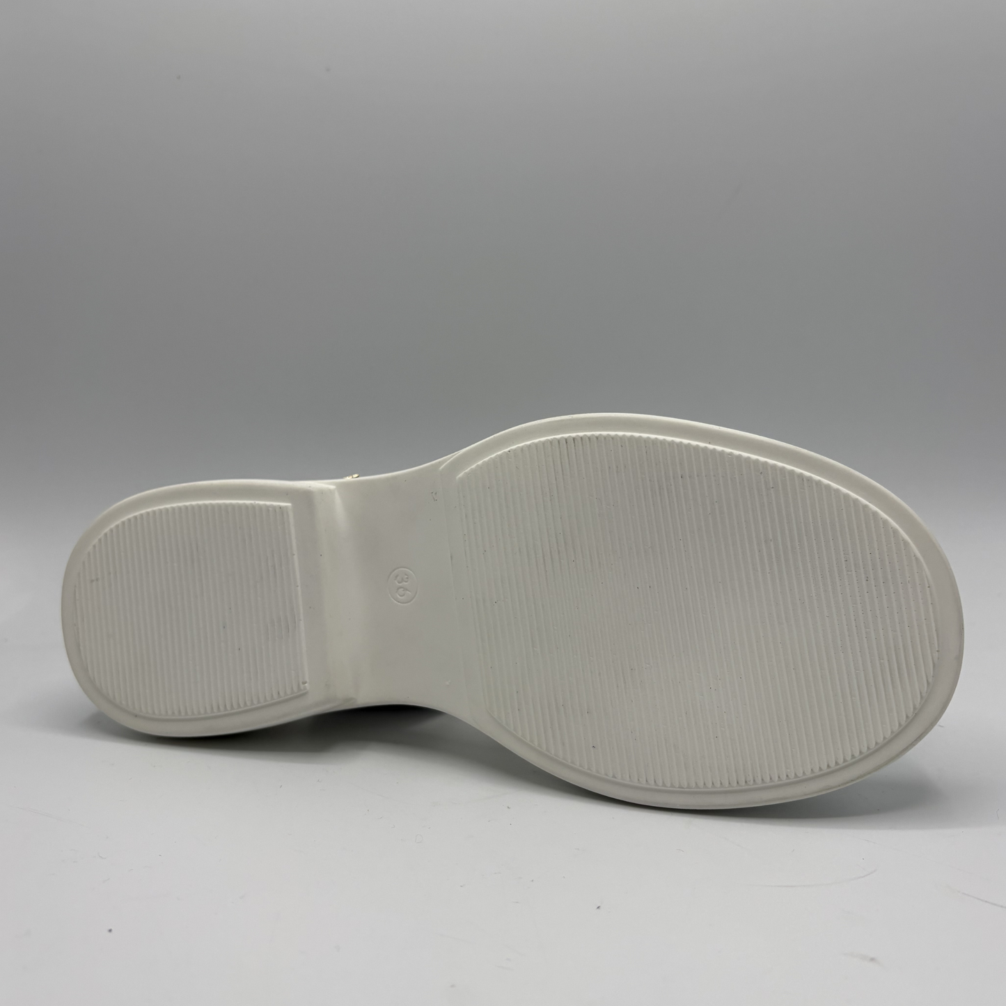 White sole of a shoe on a gray background