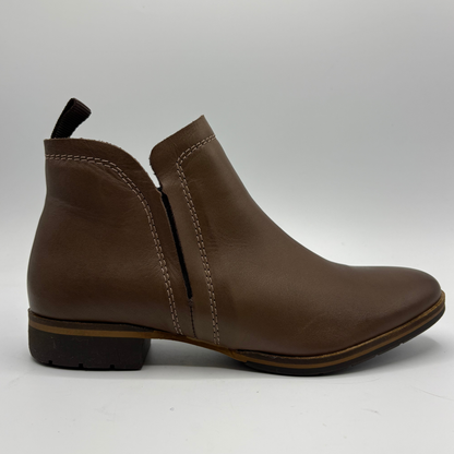 A brown leather ankle boot with a side zipper, contrast stitching, and a low block heel, shown from a side profile view on a light gray background.