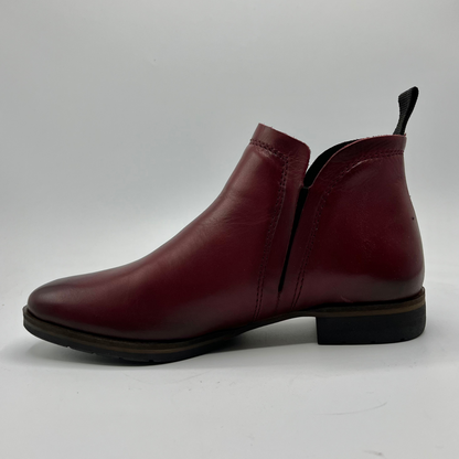 Single maroon leather boot on a white background