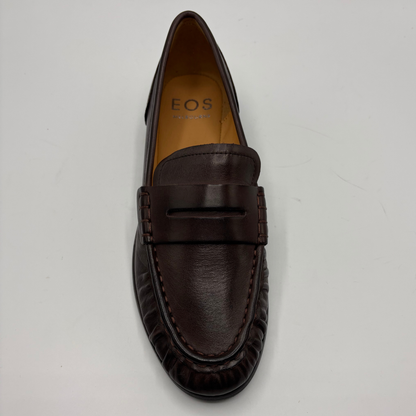 A dark brown leather loafer from EOS, photographed from a top-down angle on a light gray background.