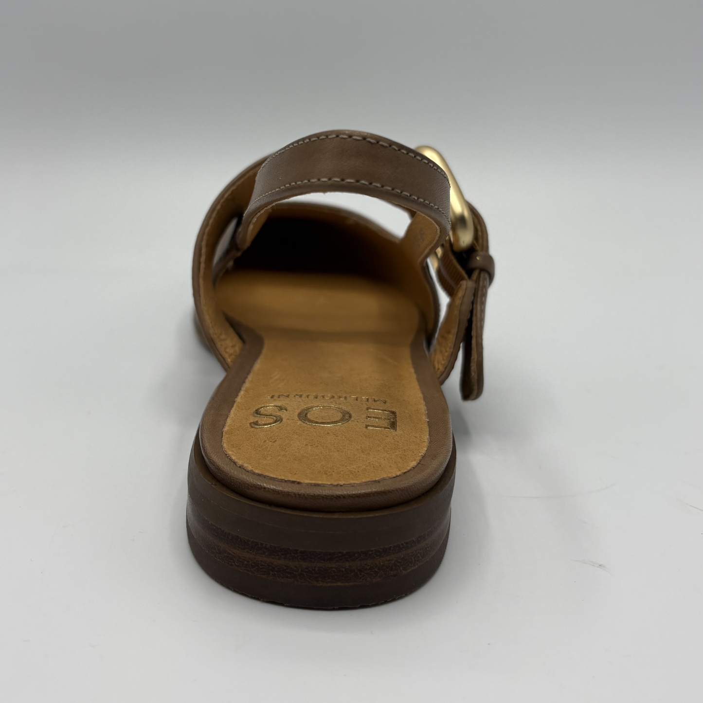 Brown sandal with a gold buckle on a white background
