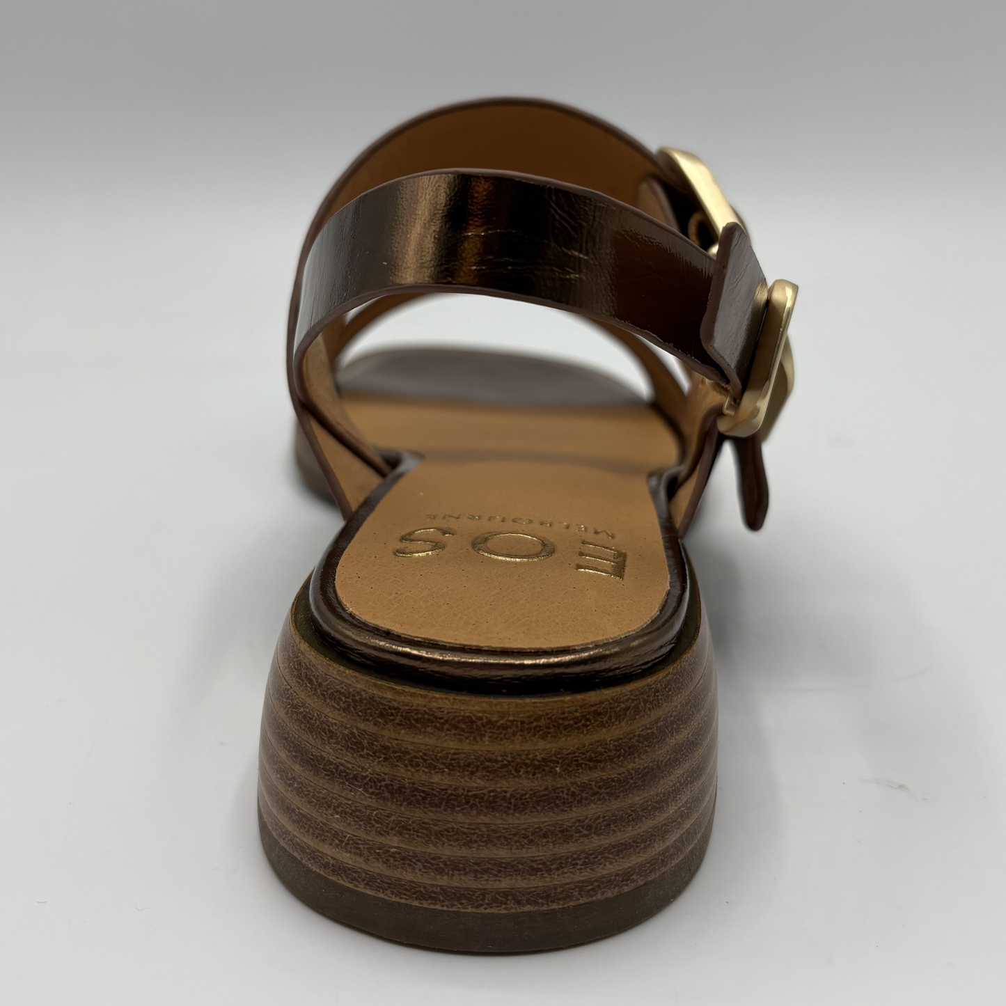 Brown sandal with a strap and buckle on a white background