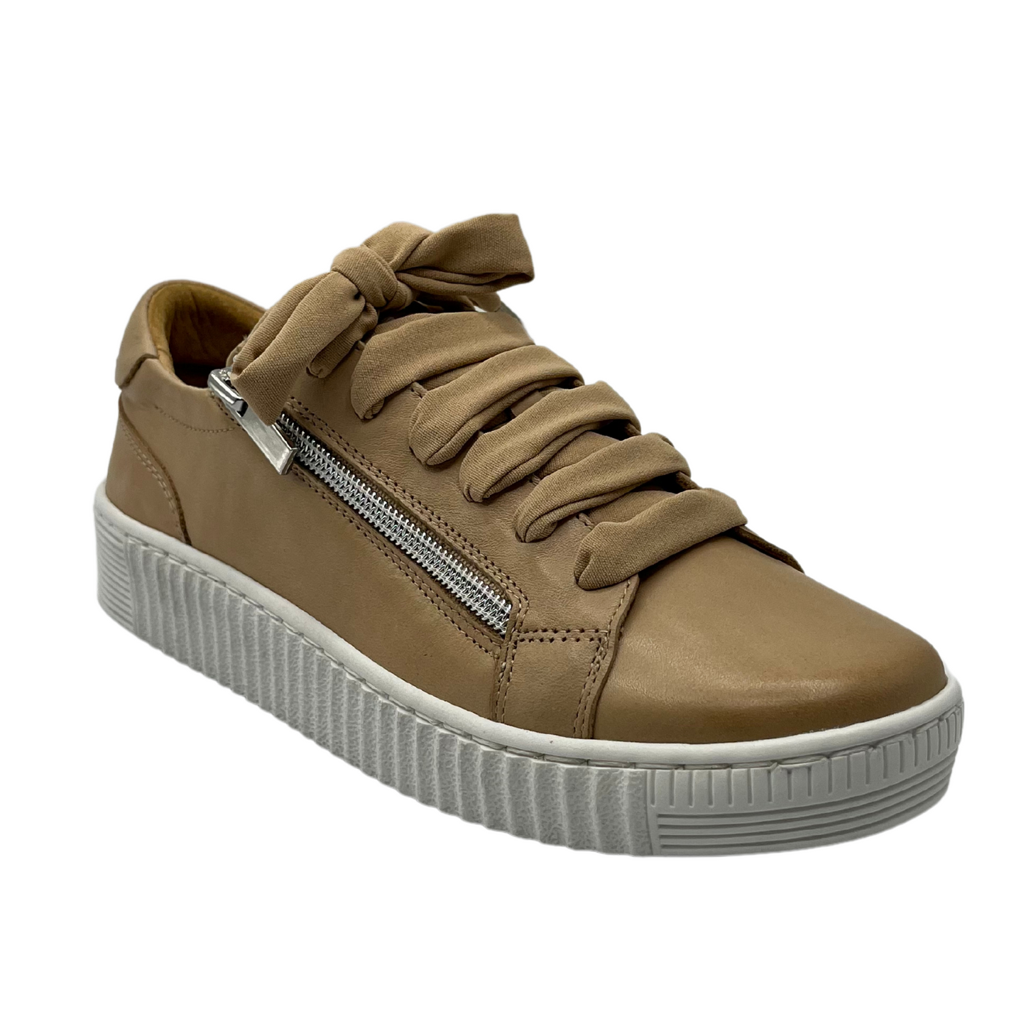 45 degree angled view of nude leather sneaker with matching laces and silver side zipper. White rubber outsole