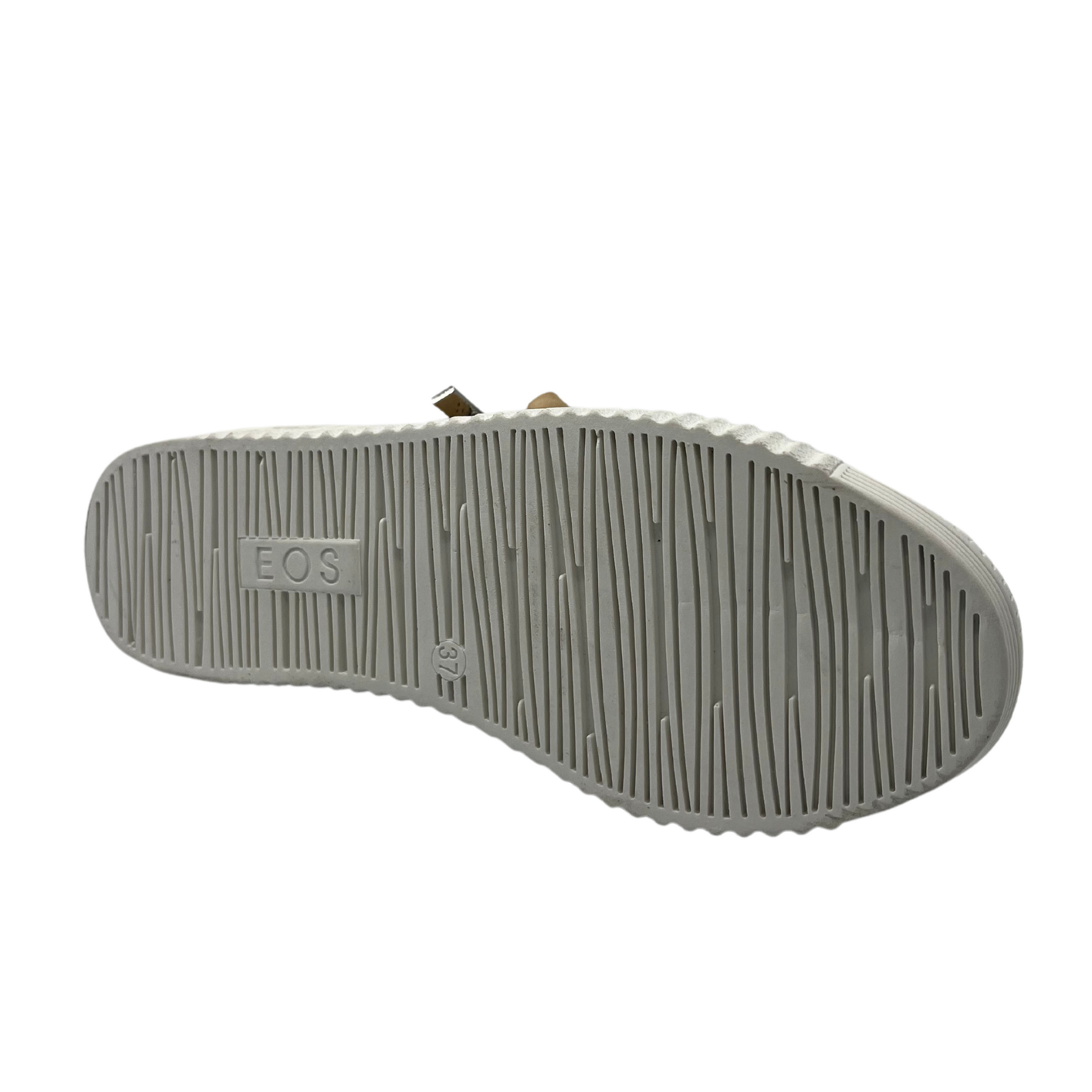 Bottom view of nude leather sneaker with white rubber outsole