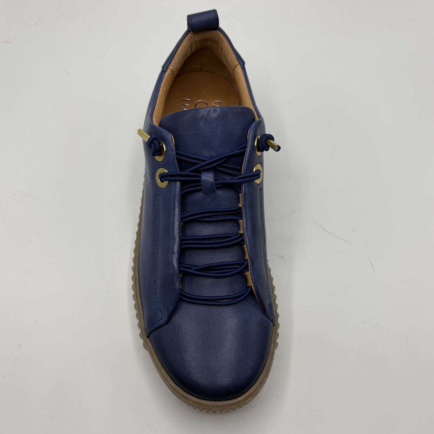 Blue leather shoe on a light gray background