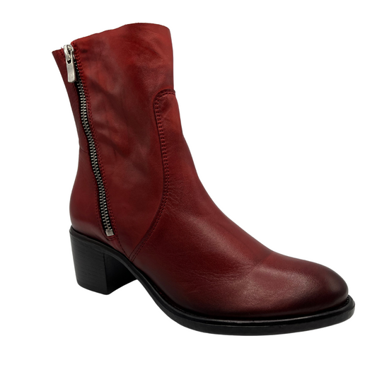 45 degree angled view of red leather calf height boot with block heel and silver side zipper