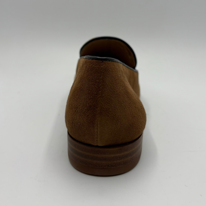 Back view of a brown leather loafer with a short stacked heel on a white background