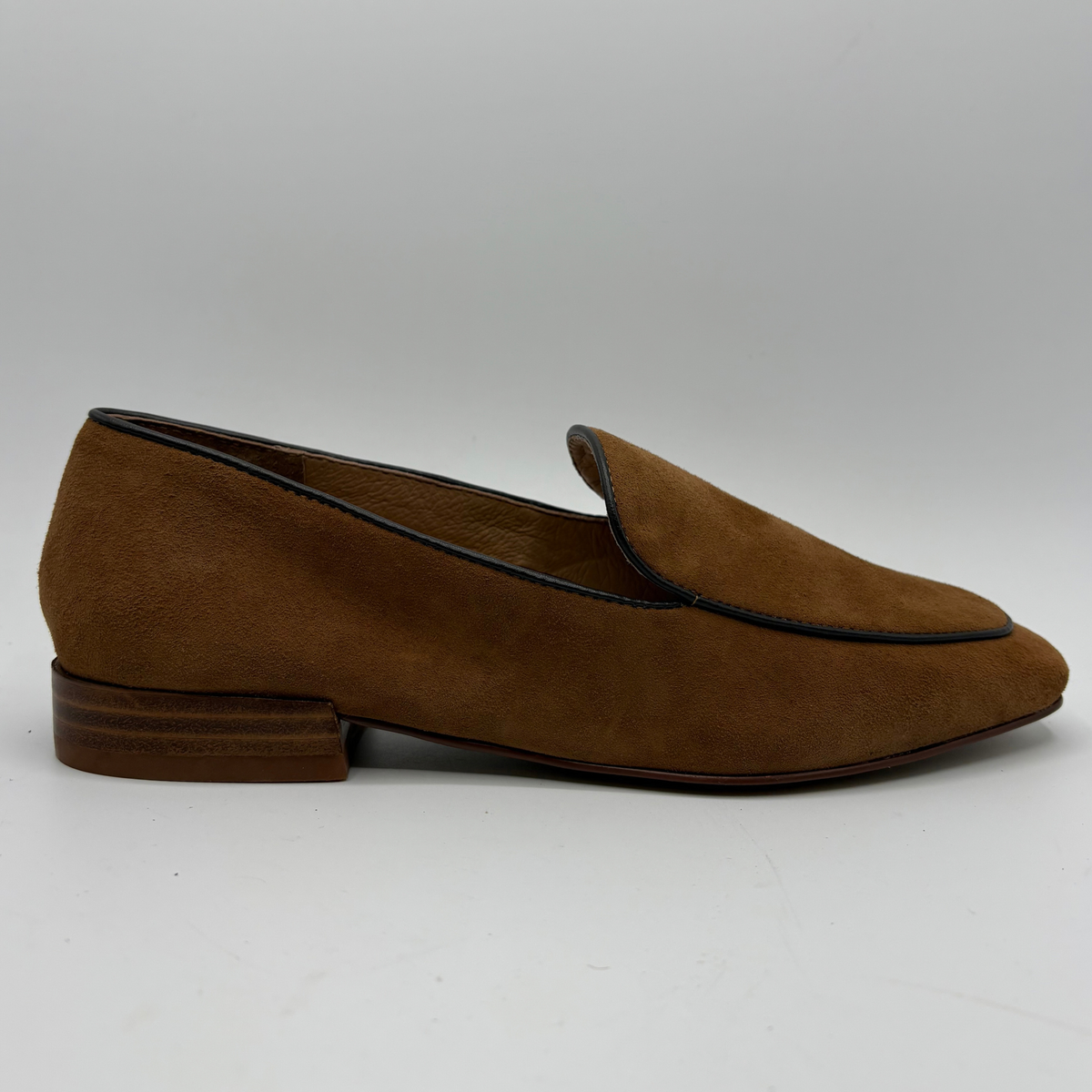 Right facing view of a brown leather loafer with a short stacked heel on a white background